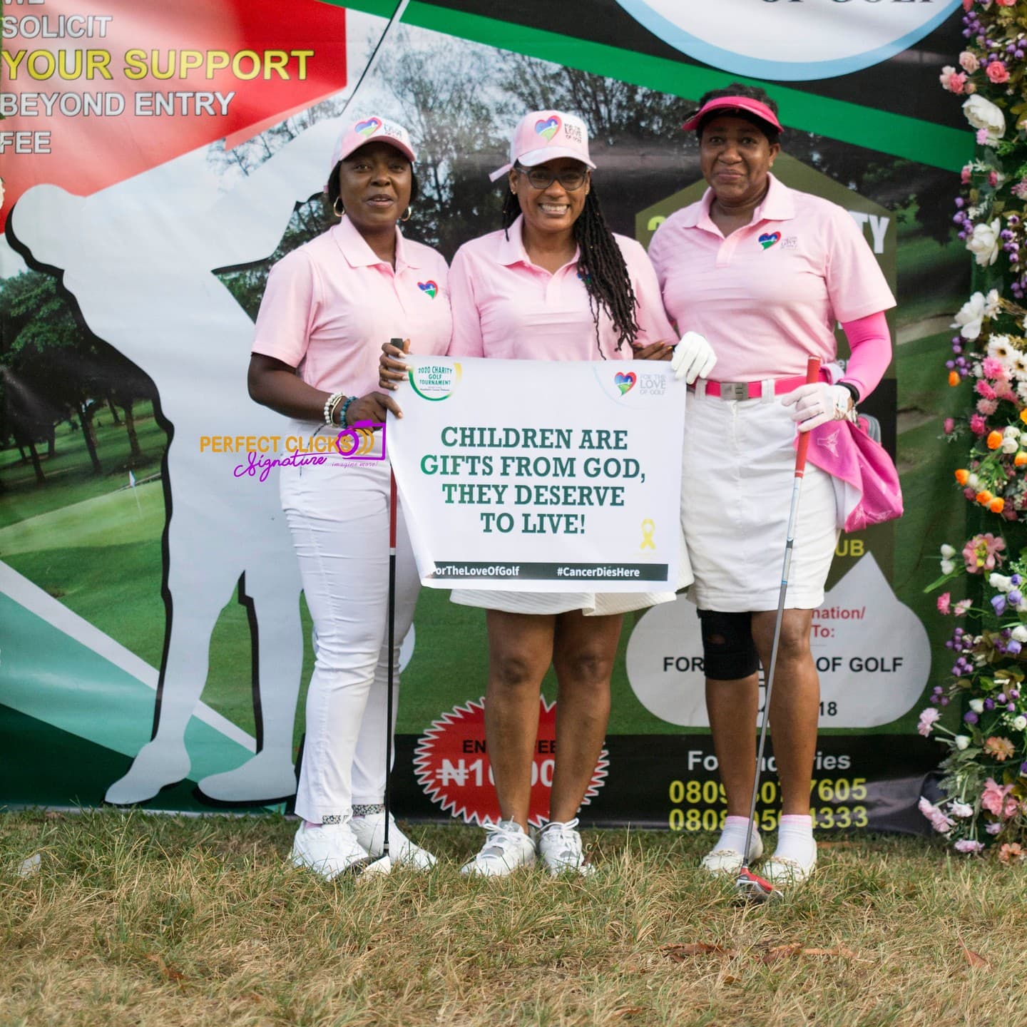 Three golfers in pink showing their support for children affected by cancer at a charity golf tournament