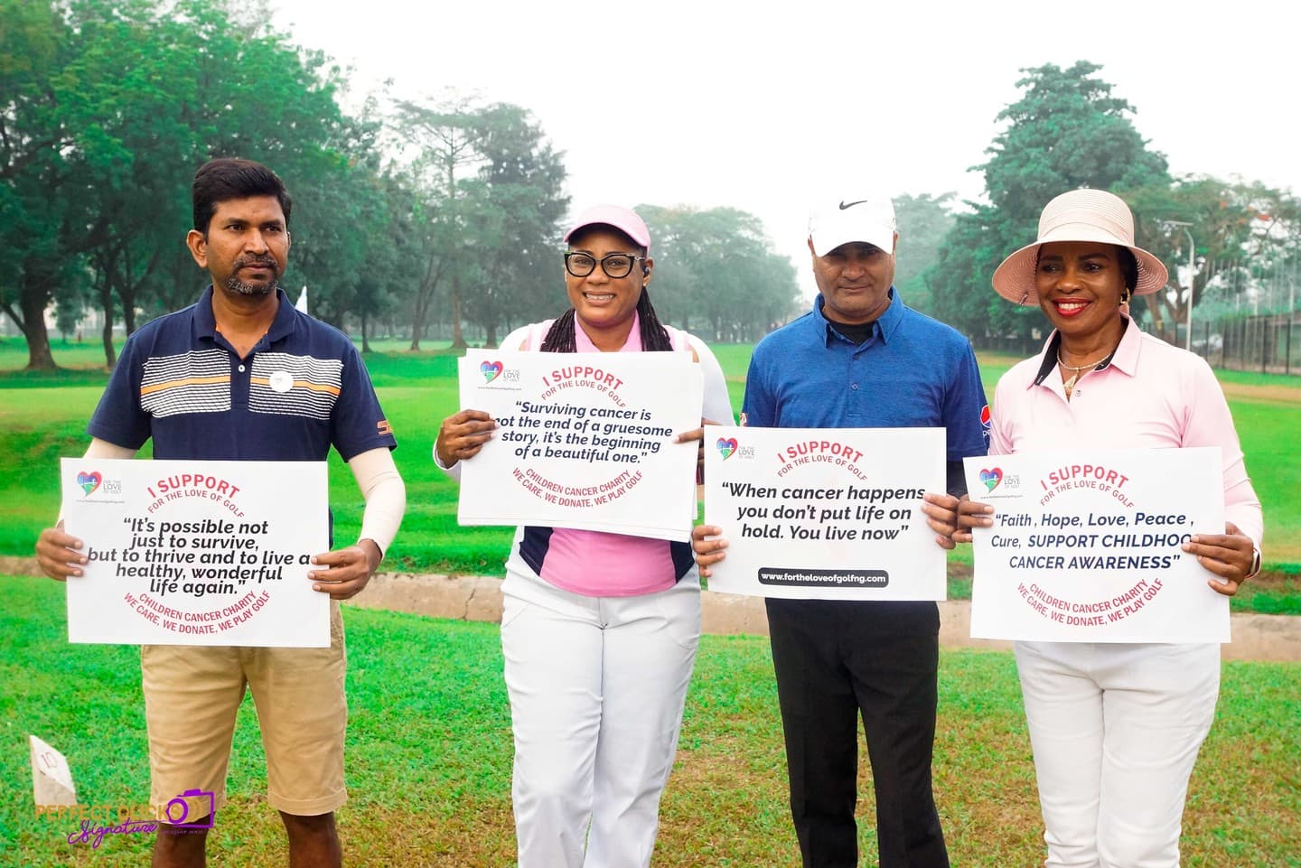 Four golfers on the course holding messages of support for childhood cancer awareness